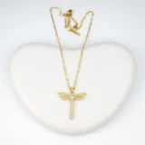 Close-up view of dragonfly gold pendant necklace with diamond stones